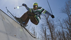 Skier grinding an edge at the terrain park on Whiteface Mountain