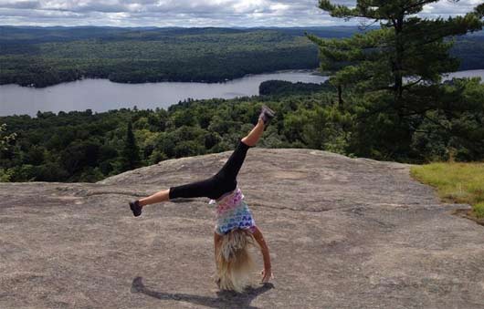 girl cartwheeling on mountain