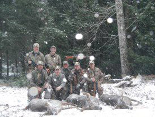 Hunting party in Adirondack snow with three white-tailed deer