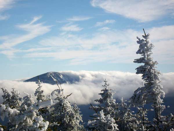 Clouds shrouding a mountain peak in winter