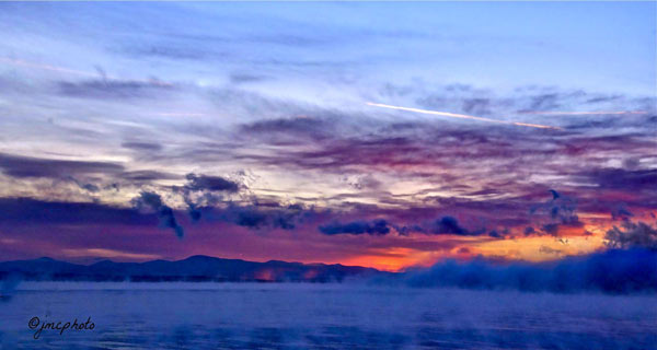 Fog over a lake at sunrise