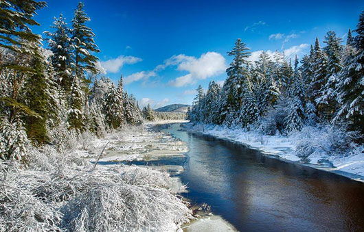 a long stream with snow nearby