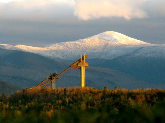 olympic ski jumps in front of Mount Marcy in golden light