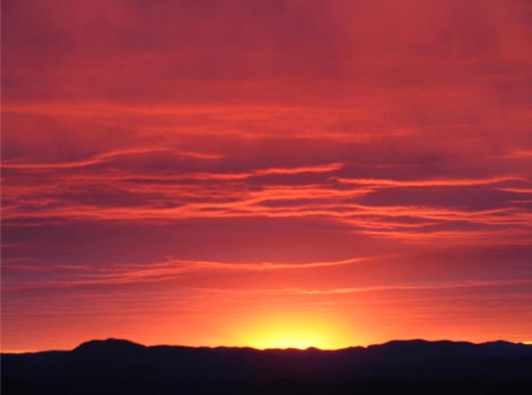 red sunrise over a ridge