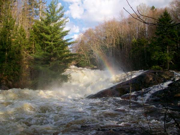 rushing waters and mist creating a rainbow