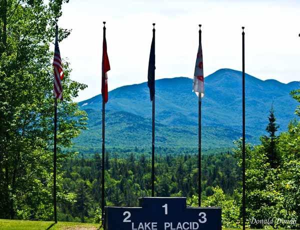 Olympic medal stand backed by flags Whiteface Mountain