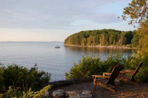 Adirondack chairs on the lake shore