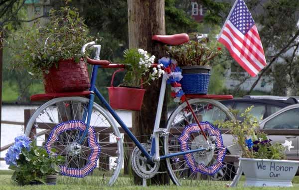 Patriotic bicycle covered in flower pots