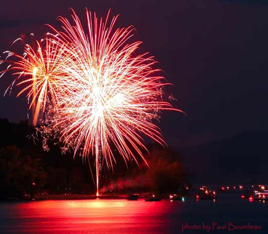 Red fireworks bursting over Great Sacandaga Lake