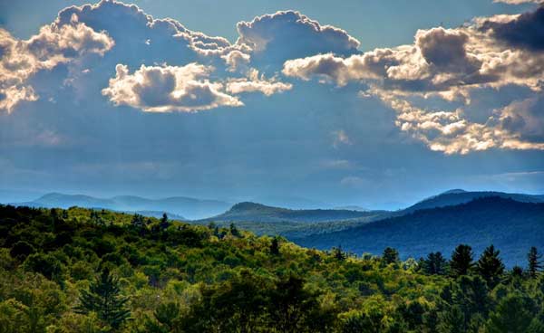 View of Adirodnack mountains backed by billowing clouds