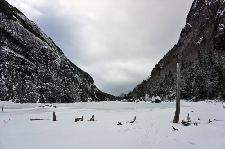 Frozen lake between snowy mountains