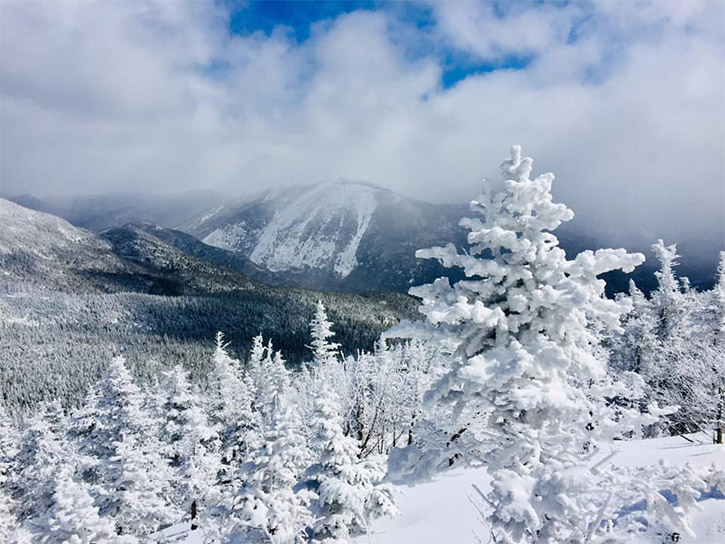 view of one snowy mountain summit from another