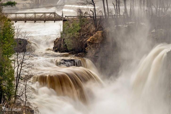 Two large waterfalls on a misty cloudy day