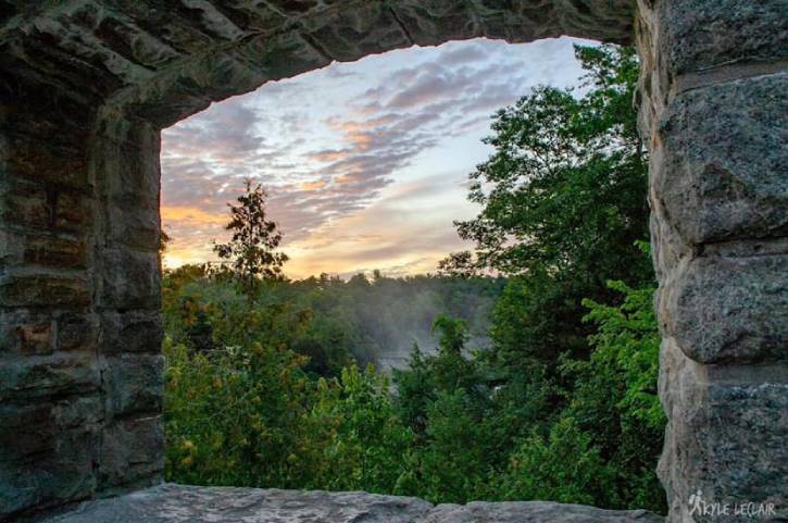 Sunrise through window in a stone bridge