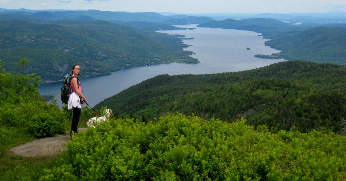 hiker with dog on summit