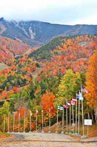 flags in front of Whiteface Mountain with fall foliage