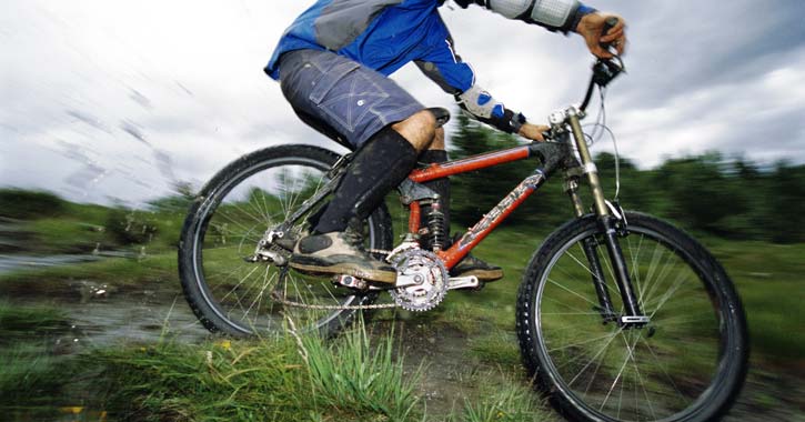 a person going fast on a mountain bike