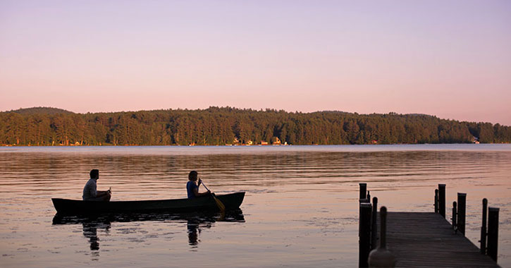 two people in a canoe on the lake