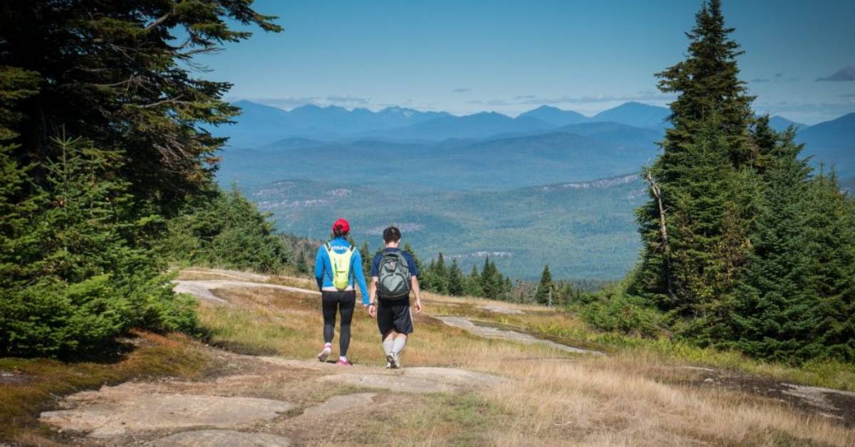 two people hiking on a mountain trail