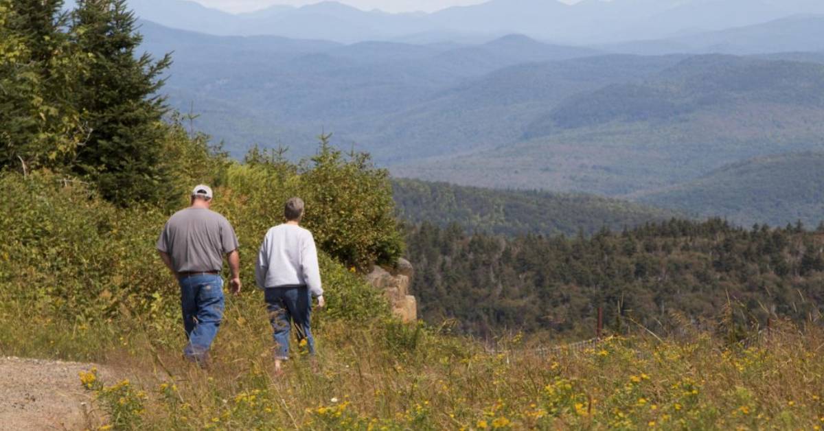 two people hiking on mountain trail