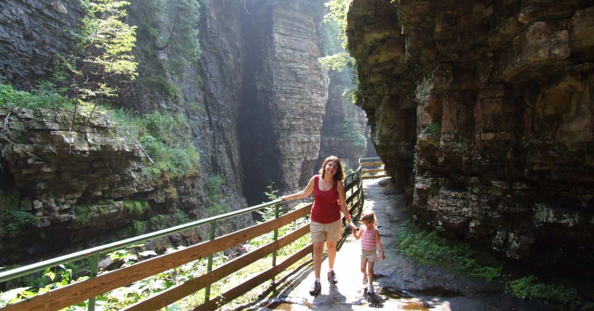 a mom and daughter hiking through ausable chasm