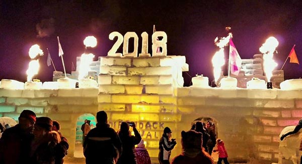 people taking photographs of an ice palace