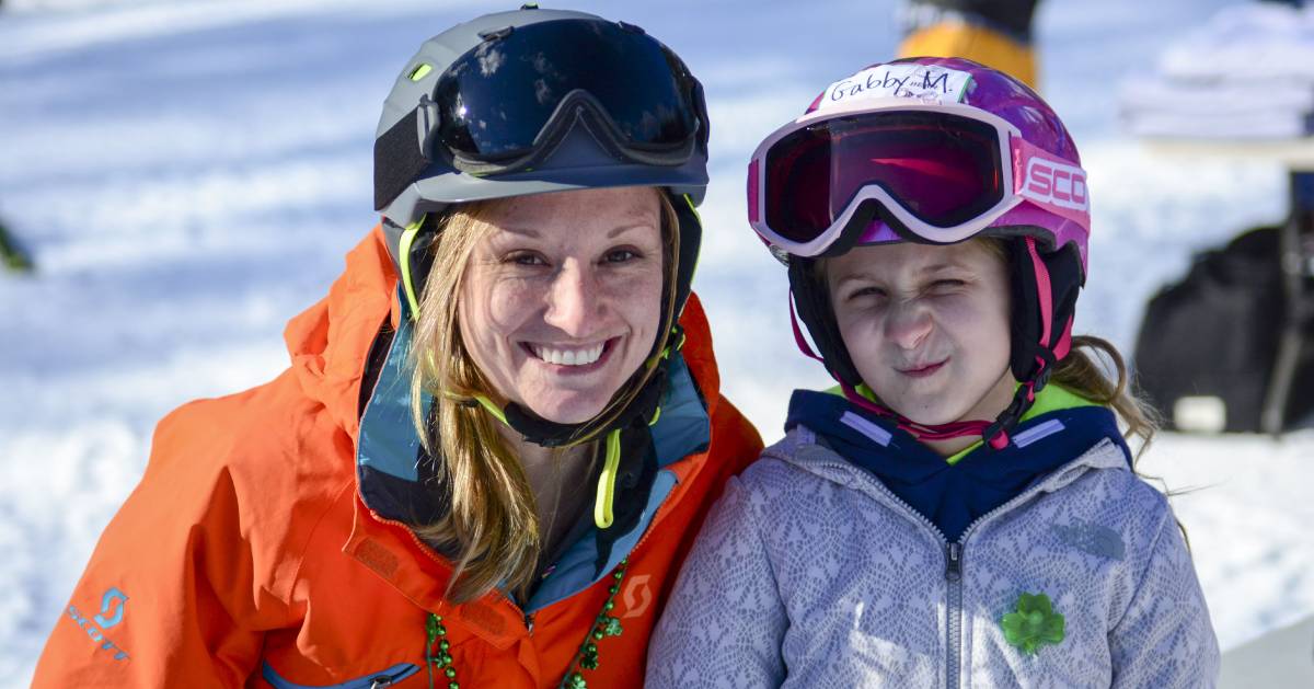 a woman and girl in ski gear posing