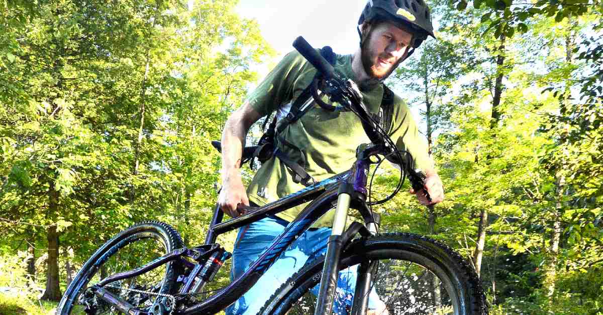 mountain biker carrying his bike