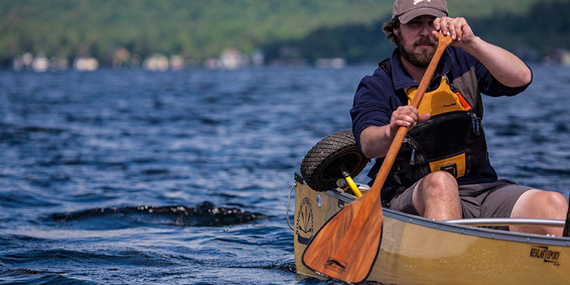 solo paddler through a lake