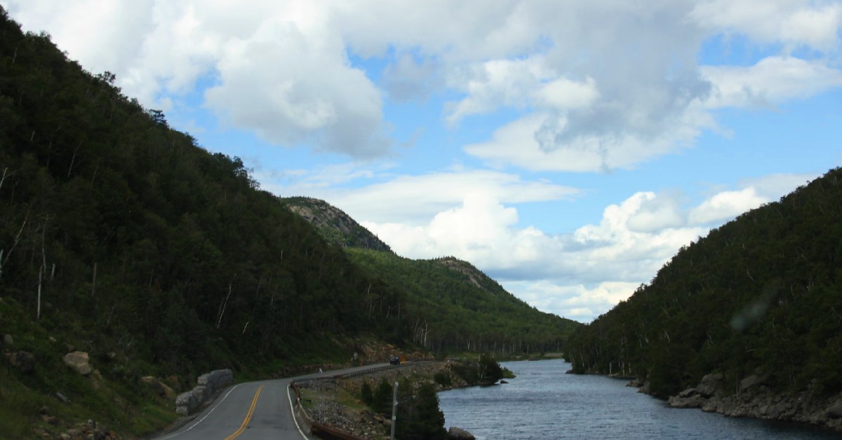 a road along the water near lake placid