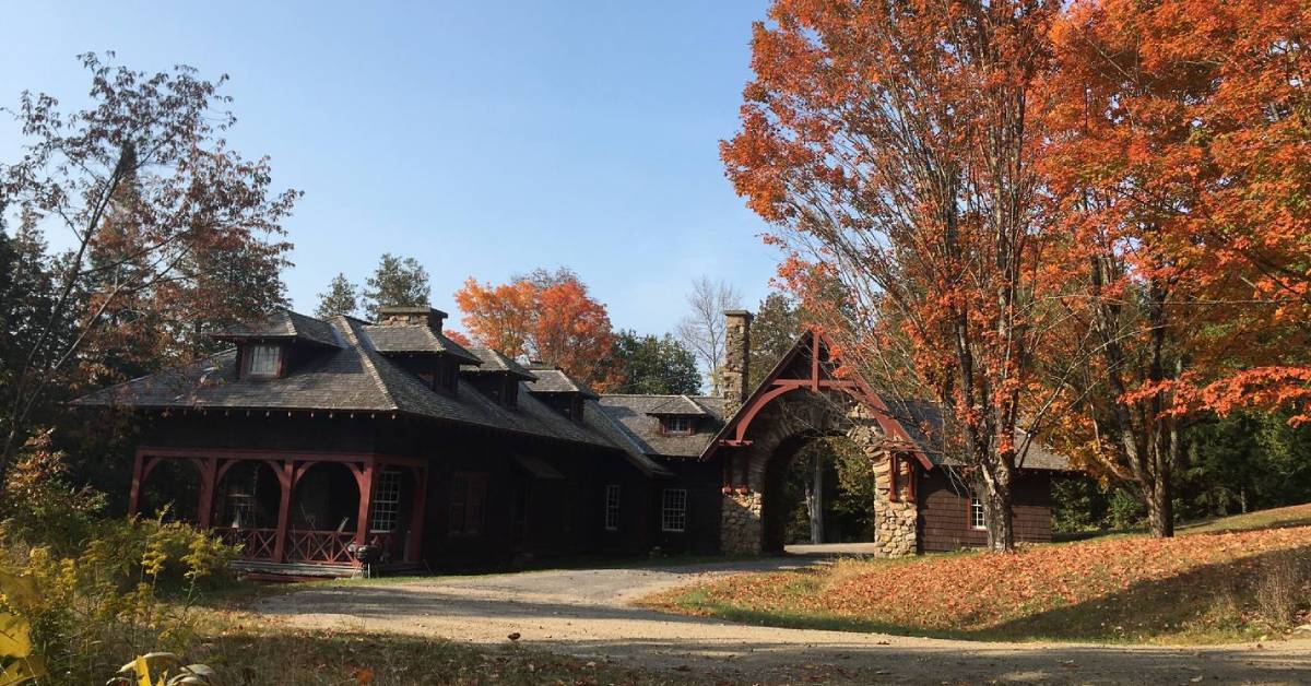 a wooden and stone building in the woods