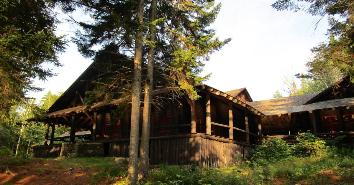 a wooden building in the woods