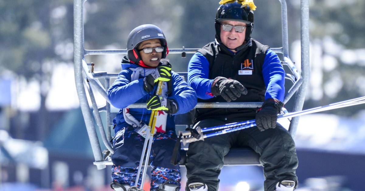 man and boy on ski lift