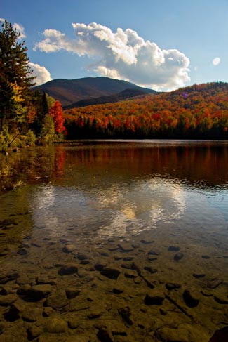 clear waters lined by fall foliage