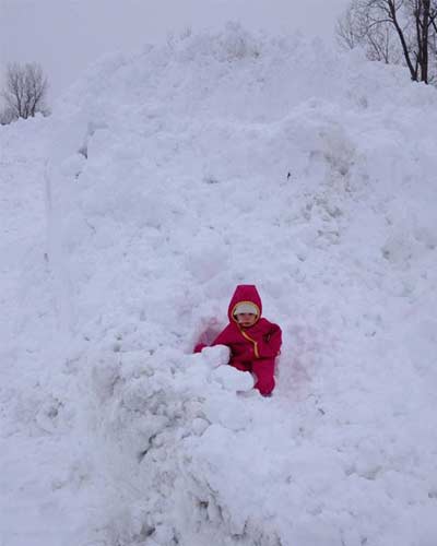 kid in snow pile